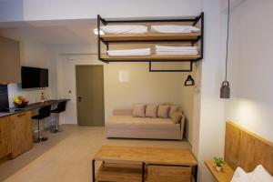 a room with a bed and a desk and a couch at Haus Riviera in Asprovalta