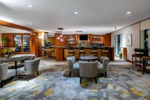 a lobby with tables and chairs and a bar at Hilton Garden Inn Tysons Corner in Tysons Corner