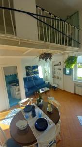 a living room with a table and a blue couch at Dimora Sorrento in Sant'Agnello