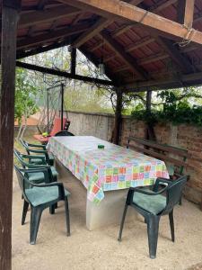 a table and chairs sitting under a pavilion at Vikendica S, Alibegovac in Petrovaradin
