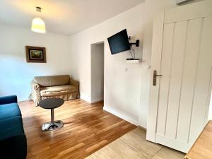 a living room with a couch and a chair at Familly Apartament 4 in Międzyzdroje