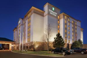 a hotel building with a truck parked in front of it at Embassy Suites by Hilton Denver International Airport in Denver