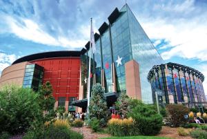 a large glass building with a flag on it at Embassy Suites by Hilton Denver International Airport in Denver