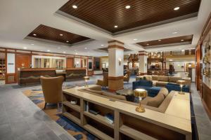 a lobby of a hotel with a living room at Embassy Suites by Hilton Denver International Airport in Denver