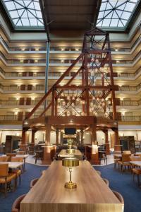 a large room with a wooden table and chairs at Embassy Suites by Hilton Denver International Airport in Denver