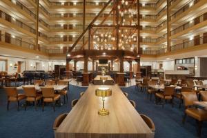 a large dining room with tables and chairs at Embassy Suites by Hilton Denver International Airport in Denver
