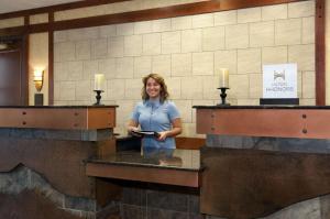 a woman standing at a counter in a hotel room at Embassy Suites by Hilton Denver International Airport in Denver