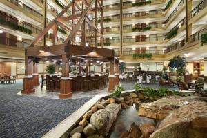a lobby of a hotel with a large building at Embassy Suites by Hilton Denver International Airport in Denver