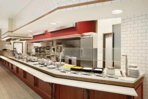 a large kitchen with many dishes on a counter at Embassy Suites by Hilton Denver International Airport in Denver