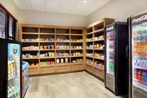 a store aisle with shelves of food and drinks at Embassy Suites by Hilton Denver International Airport in Denver