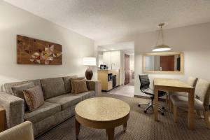 a living room with a couch and a table at Embassy Suites by Hilton Denver International Airport in Denver