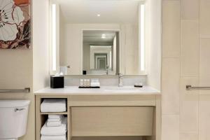 a bathroom with a sink and a mirror at Embassy Suites by Hilton Denver International Airport in Denver