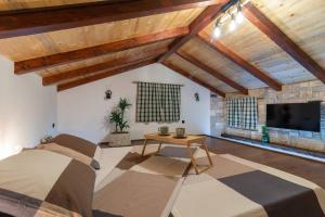 a large room with a bed and a tv at Trapula stone paradise in Maslinica +37 photos