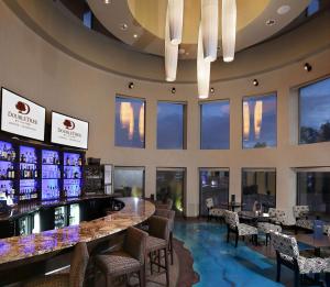 a bar in a restaurant with a lot of windows at DoubleTree by Hilton Hotel Denver - Thornton in Thornton