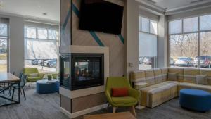 a living room with a couch and a flat screen tv at Hilton Garden Inn Plymouth in Plymouth