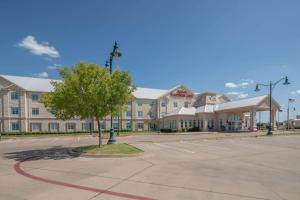 a parking lot in front of a large building at Hilton Garden Inn Granbury in Granbury