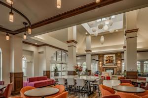 a dining room with tables and chairs at Hilton Garden Inn Granbury in Granbury