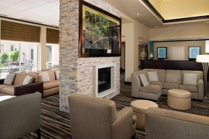 a lobby with a living room with a fireplace at Hilton Garden Inn DFW Airport South in Irving