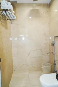 a bathroom with a toilet and a sink at Hotel Batra Home Nizamuddin in New Delhi