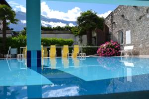 a view of a pool with chairs and flowers at Residence San Luigi in Limone sul Garda