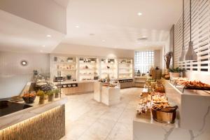 a large kitchen with a buffet of food at Hilton Darwin in Darwin