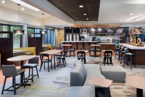 a restaurant with tables and chairs and a bar at Courtyard by Marriott Tarrytown Westchester County in Tarrytown