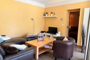 a living room with a couch and a coffee table at Ferienhaus Müritzzeit in Röbel an der Müritz in Marienfelde