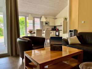 a living room with a couch and a table at Ferienhaus Müritzzeit in Röbel an der Müritz in Marienfelde