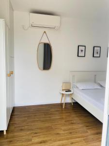a bedroom with a bed and a mirror on the wall at Daro tiny house in Vama Veche