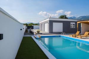 a swimming pool in front of a house at Vila Nur Mostar in Mostar