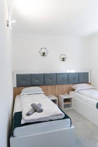 two beds in a room with two towels on them at Vila Nur Mostar in Mostar