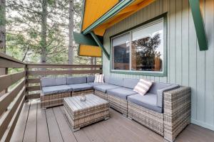 un patio avec un canapé et une table sur une terrasse dans l'établissement The Mod Lodge - Lake Arrowhead, à Lake Arrowhead