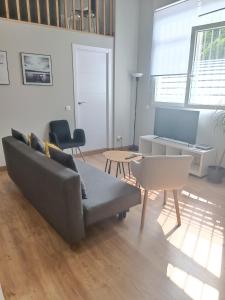 a living room with a couch and a table at Apartamento pacifico a in Madrid