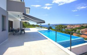 a view from the balcony of a villa with a swimming pool at Unique Apartment with private pool in Krk