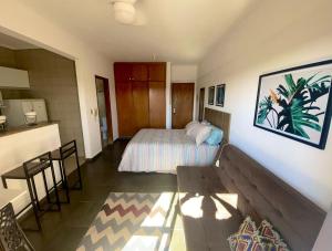 a hotel room with a bed and a table at Ravena 016 in Ribeirão Preto