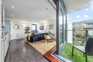 a living room with a couch and a table at Lovely & Cosy 2 Beds London skyline view in London