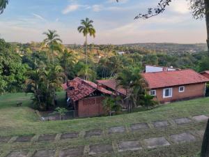 a house on a hill with palm trees at Chacara Vale dos Sonhos Itu in Itu