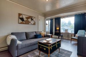 a living room with a couch and a table at #StayinMyDistrict Historic Apartment Near Downtown in Coos Bay