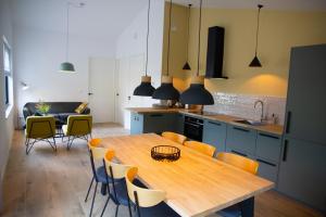 een keuken met een houten tafel en stoelen bij Eco lodge Duin- unieke locatie nabij strand, duin en cultuur in Castricum