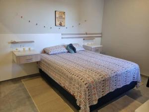 a bedroom with a large bed with a nightstand and a bed sidx sidx sidx at Apartamento en Asunción in Asunción