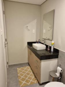 a bathroom with a sink and a mirror at Apartamento en Asunción in Asuncion