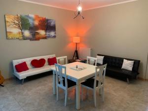 a living room with a table and a couch at IL Lago dei sogni in Posta Fibreno