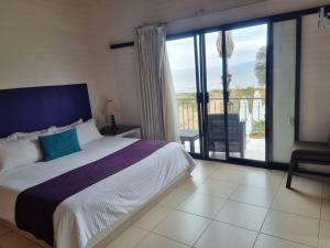 a bedroom with a bed and a view of the ocean at Hotel La Ribereña in Ajijic