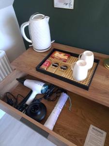 a wooden desk with a table with a tea pot on it at The Lookout in Bromsgrove
