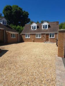 a large house with a large gravel driveway at The Lookout in Bromsgrove