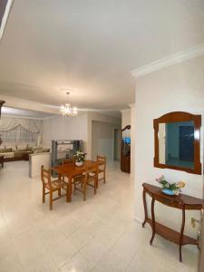 a living room with a table and a dining room at Centre ville appartement in Al Hoceïma