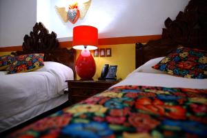 Postel nebo postele na pokoji v ubytování HOTEL CASA BAEZ