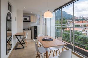 a kitchen and dining room with a table and chairs at Anima 64 in Bogotá