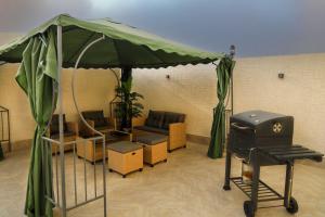 a tent with a grill in a room at نزل ليلى الفندقية الفاخرة luxury in Abha