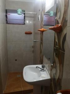 a bathroom with a sink and a shower at Mi Angeline in Sucre